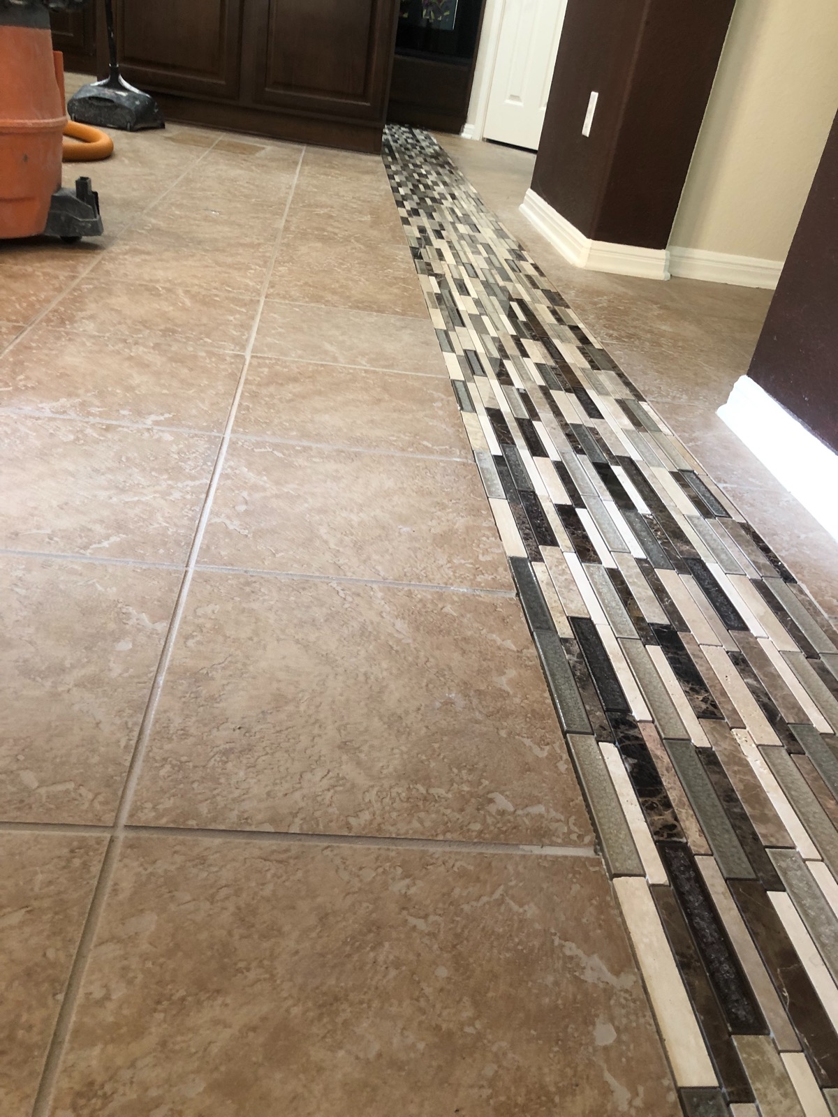 Travertine floor with glass and stone mosaic inlay