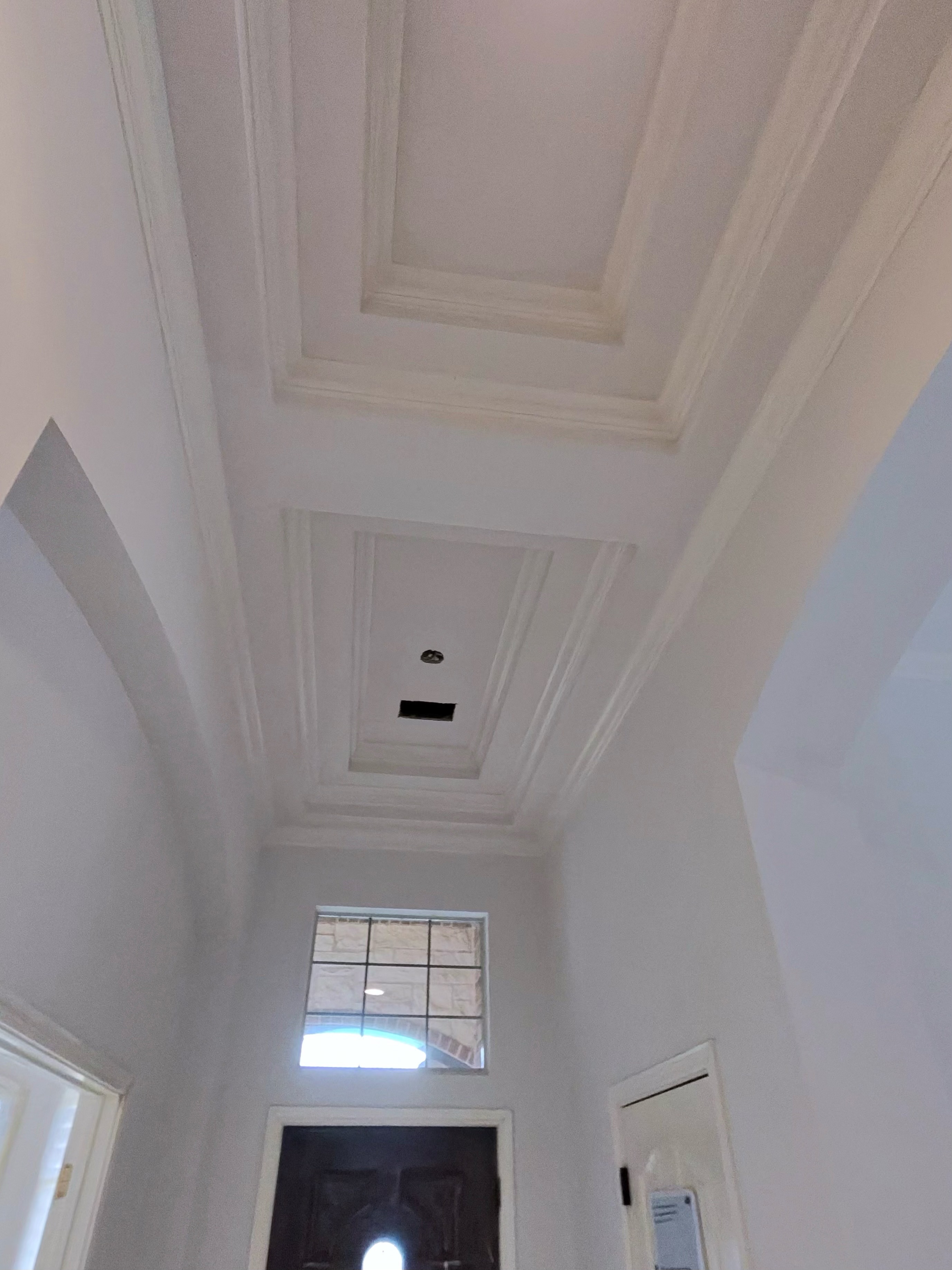 Two-story foyer with crown molding